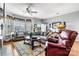 Comfortable living room featuring hardwood floors, large windows, neutral decor, and ample seating at 5472 Ives Nw St, Concord, NC 28027