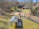 Scenic aerial view of a lakeside home with a private dock and boat shelter, perfect for enjoying water activities at 5981 Johnson Rd, Lake Wylie, SC 29710
