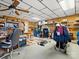 Organized basement office and storage area, equipped with shelving, desk, and a wheeled clothing rack at 5981 Johnson Rd, Lake Wylie, SC 29710