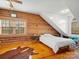 Cozy bedroom features natural wood walls, flooring and ceiling fan, creating a rustic and inviting retreat at 5981 Johnson Rd, Lake Wylie, SC 29710