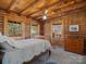 Cozy bedroom with two windows allowing natural light with wooden beams and a dresser at 5981 Johnson Rd, Lake Wylie, SC 29710