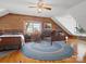 Inviting bedroom boasts natural wood walls, window views, and a ceiling fan for comfort and character at 5981 Johnson Rd, Lake Wylie, SC 29710
