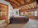 Bedroom featuring wooden beams, a cozy window seat, and an iron bed frame at 5981 Johnson Rd, Lake Wylie, SC 29710