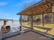 Covered boat dock with a cozy seating area, providing direct access to the serene waters for boating and relaxation at 5981 Johnson Rd, Lake Wylie, SC 29710