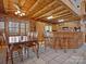 Open dining room with a large table and views of the surrounding nature at 5981 Johnson Rd, Lake Wylie, SC 29710
