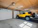 Garage interior with a yellow SUV parked inside, featuring bright lighting and white doors at 5981 Johnson Rd, Lake Wylie, SC 29710