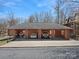 Exterior shot of a log-style garage with three bays, featuring a yellow SUV and other vehicles inside at 5981 Johnson Rd, Lake Wylie, SC 29710