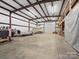 Large garage space with high ceilings and a boat parked inside at 5981 Johnson Rd, Lake Wylie, SC 29710