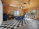 Spacious garage with a black and white checkered floor, storage shelves, and multiple bicycles at 5981 Johnson Rd, Lake Wylie, SC 29710
