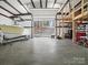 Spacious garage features ample storage space for boats, equipment, and tools, keeping everything organized and accessible at 5981 Johnson Rd, Lake Wylie, SC 29710