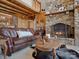 Inviting living room with a stone fireplace and cozy leather sofa at 5981 Johnson Rd, Lake Wylie, SC 29710
