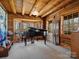 Cozy room with a black piano, featuring wood-paneled walls and ceiling that create a warm, inviting ambiance at 5981 Johnson Rd, Lake Wylie, SC 29710