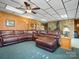 Spacious living room offering a large brown leather couch and a fireplace at 5981 Johnson Rd, Lake Wylie, SC 29710