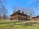 Expansive log home with a wraparound porch on a large lot, offering picturesque views and outdoor living space at 5981 Johnson Rd, Lake Wylie, SC 29710