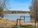 Scenic waterfront view showcasing a private dock with a charming gazebo, surrounded by serene water and lush landscapes at 5981 Johnson Rd, Lake Wylie, SC 29710