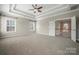 Spacious bedroom with tray ceiling, carpet, and view of hallway at 714 Castlestone Ln, Matthews, NC 28104