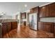 Spacious kitchen featuring wood cabinets, stainless steel appliances, granite countertops and hardwood floors at 714 Castlestone Ln, Matthews, NC 28104