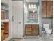 Bathroom featuring a single vanity, toilet, and tiled shower, adjacent to bedroom at 800 Woodlawn St, Belmont, NC 28012