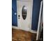 Entryway featuring a white front door with an oval glass window, set against blue walls and hardwood floors at 800 Woodlawn St, Belmont, NC 28012