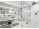Bright bathroom featuring double sinks, large glass-enclosed shower, and white marble at 8104 Stem Ct, Charlotte, NC 28227