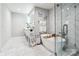 Bright bathroom boasting a luxurious soaking tub, glass-enclosed shower, and contemporary design at 8104 Stem Ct, Charlotte, NC 28227