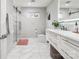 This bathroom features a glass shower, vanity with modern fixtures, and white marble tile at 8104 Stem Ct, Charlotte, NC 28227