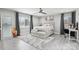 Bright bedroom featuring neutral tones, large windows, wood-look flooring, and a ceiling fan at 8104 Stem Ct, Charlotte, NC 28227