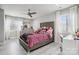 This bedroom features a silver bed frame, gray wood-look floors, and white curtains at 8104 Stem Ct, Charlotte, NC 28227