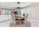 Bright dining room with modern light fixture and a round table at 8104 Stem Ct, Charlotte, NC 28227