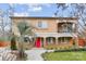 Inviting two-story home featuring a bright red door, lush landscaping, and a charming second-story balcony at 8104 Stem Ct, Charlotte, NC 28227