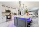 Modern kitchen featuring a large island with quartz countertops, stainless steel appliances, and stylish pendant lighting at 8104 Stem Ct, Charlotte, NC 28227