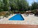 Sparkling pool surrounded by a large patio area, perfect for lounging and outdoor entertaining at 8104 Stem Ct, Charlotte, NC 28227