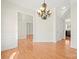 Elegant dining room featuring hardwood floors, chandelier, and classic wainscoting at 8251 Kale Pl, Harrisburg, NC 28075