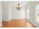 Classic dining room featuring hardwood floors, wainscoting, and a large window at 8251 Kale Pl, Harrisburg, NC 28075