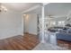 Inviting living room with hardwood floors, columns, wainscotting and a connected living space at 8433 Delberry Ln, Charlotte, NC 28277