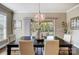 Bright dining room featuring large table, stylish chandelier, and sliding doors to a deck at 8501 Caesars Head Dr, Waxhaw, NC 28173