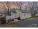 Exterior shot of a cozy home featuring a patio with seating and a grill against a colorful sky at 8639 S Nc Hwy 205 Hwy, Oakboro, NC 28129