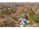 Overhead view of amenities: pools and a covered picnic area in the community surrounded by lush trees and manicured grounds at 910 Elrond Nw Dr, Charlotte, NC 28269
