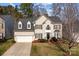 Classic two-story home featuring dormer windows, black shutters and a two car garage at 910 Elrond Nw Dr, Charlotte, NC 28269