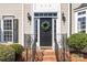 Inviting front door with sidelights, black hardware, and a decorative wreath at 910 Elrond Nw Dr, Charlotte, NC 28269