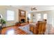 Bright living room featuring a cozy brick fireplace, hardwood floors, and ample natural light at 10207 Summer House Ct, Charlotte, NC 28210