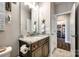 Well-lit bathroom with a granite countertop vanity, tiled floor, and doorway to another room at 1024 Mayapple Way, Belmont, NC 28012