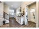 Hallway with hardwood floors and tastefully decorated console table to the living room and bathroom at 1024 Mayapple Way, Belmont, NC 28012