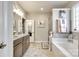 Serene bathroom boasts a luxurious soaking tub, walk-in shower, and elegant vanity, creating a spa-like retreat at 1024 Mayapple Way, Belmont, NC 28012