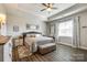 This bedroom has wood floors, a ceiling fan, and a neutral wall color at 1024 Mayapple Way, Belmont, NC 28012