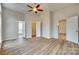 Bright bedroom with ceiling fan and three doors, including one leading to a closet, and three windows at 106 Aurora Ln # 31, Huntersville, NC 28078