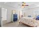 Bright bedroom featuring a four-poster bed, ceiling fan, and rocking chair at 109 Putney Ct, Salisbury, NC 28147