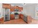 Bright kitchen with stainless steel appliances, wood cabinets, and granite countertops at 109 Putney Ct, Salisbury, NC 28147