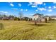 Property view showing lawn, mature trees, and several residential buildings at 109 Putney Ct, Salisbury, NC 28147