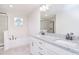 Bathroom featuring granite countertops, dual sinks, a soaking tub, and separate glass-enclosed shower at 111 Megby Trl, Statesville, NC 28677